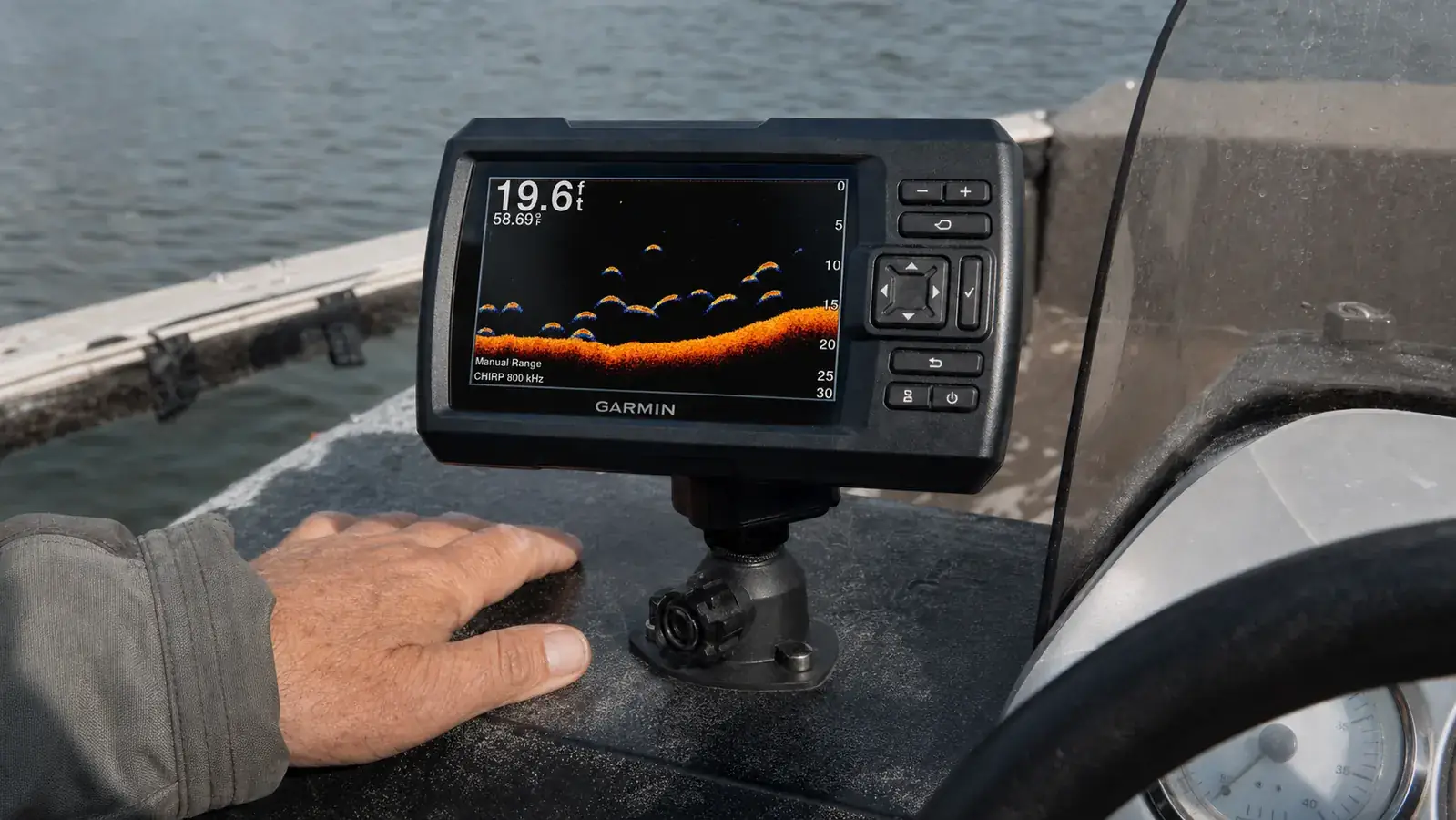 Close view of a fish finder screen showing a bottom contour line and a cluster of fish arches over a drop-off